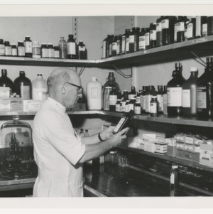 ASPCA photograph: Veterinarian inspecting bottle of medicine