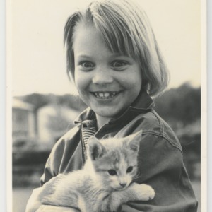 Child holding a kitten