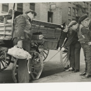 ASPCA photograph: ASPCA official demonstrates wagon hobble to wagon drivers