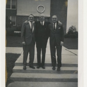 ASPCA photograph: Three men smiling outside building