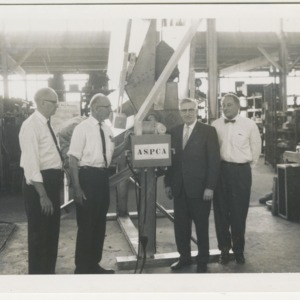 ASPCA photograph: Men standing with machine labelled "ASPCA"