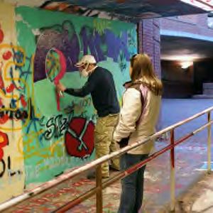 Student painting in the Free Expression Tunnel