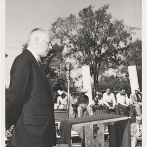 Ralph Clay Swann speaking into microphone