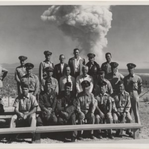 Group photo of Official Observers for Fizeau experiment, with explosion in background