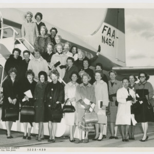 Photograph of women on plane steps