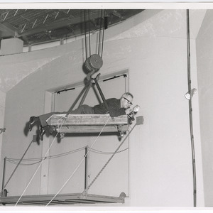 John Mattox on suspended platform with camera