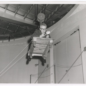 John Mattox on suspended platform with camera