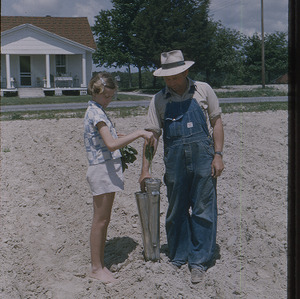 Farmer and girl in field
