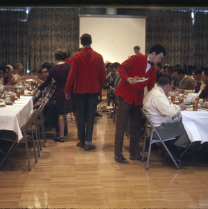 People eating at event, circa February 1968