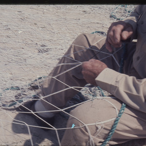 Man with fishing net, circa April 1968