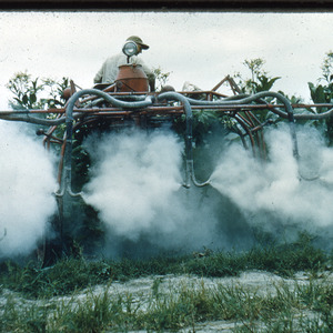 Man spraying crops in field, undated