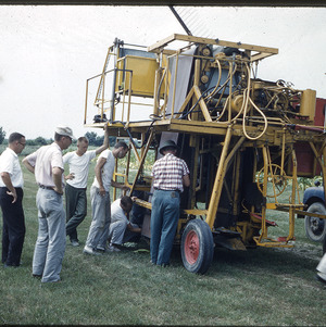 Men working on agricultural machinery, circa September 1961