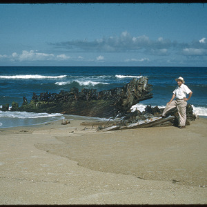 Man on beach with structure, undated