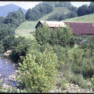 Barn next to stream in mountains, circa August 1970