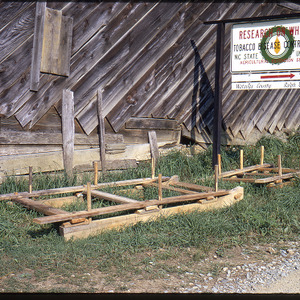 Pallets outside of barn on tobacco farm, circa August 1970