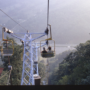 People in chair lift in mountains, circa October 1971