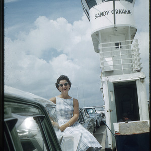 Woman posing with car on Sandy Graham ferry, undated