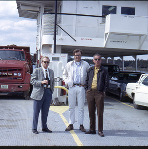 Dr. Frank Thomas standing with men on car ferry, circa May 1971