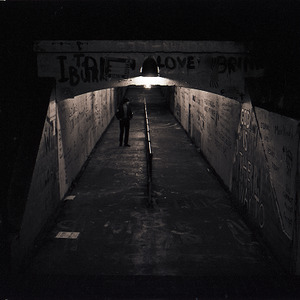 Person walking in Free Expression Tunnel at night, circa 1969-1975