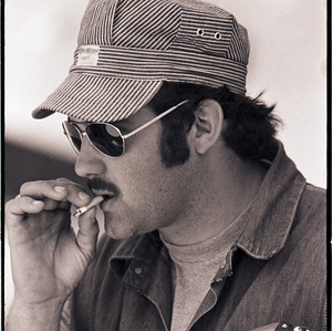 Man smoking at Earl Scruggs performance, circa 1971-1972