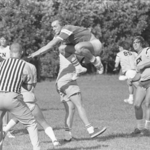 Students playing football, circa 1969-1975