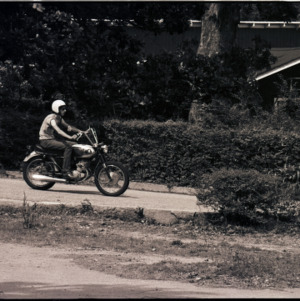 Young adult on motorcycle, circa 1969-1975