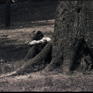 Child by tree, circa 1969-1975