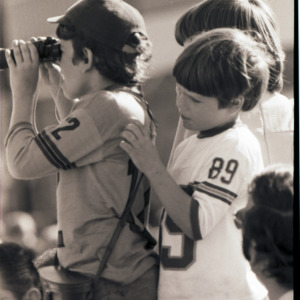 Children with binoculars, circa 1969-1975