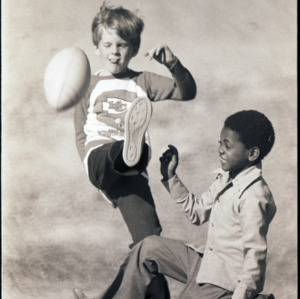 Children kicking a football, circa 1969-1975