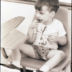 Child with ice cream, circa 1969-1975