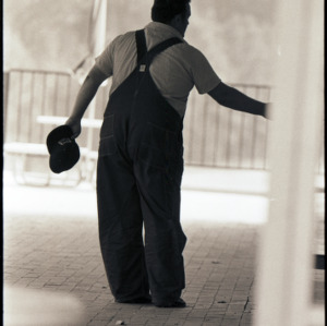 Man in overalls, circa 1969-1975
