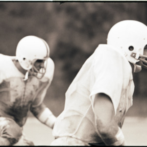 Football players at practice, circa 1969-1975