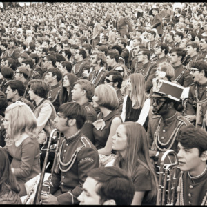 Marching band and spectators in stands, 1969
