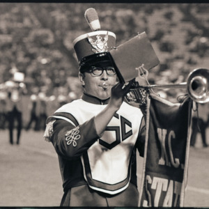 Trumpet player at football game, circa 1969-1975
