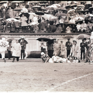 Football players and spectators at NC State versus Duke game, circa 1969-1975