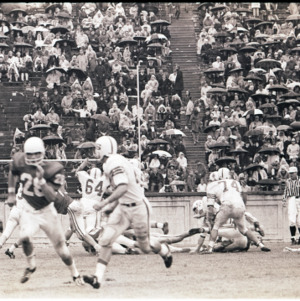 Football players and referees at NC State versus Duke game, circa 1969-1975
