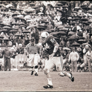 Football players and referee at NC State versus Duke game, circa 1969-1975
