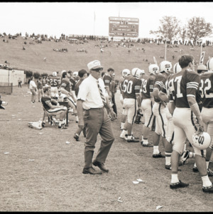 Football coach and players at NC State versus Duke game, circa 1969-1975