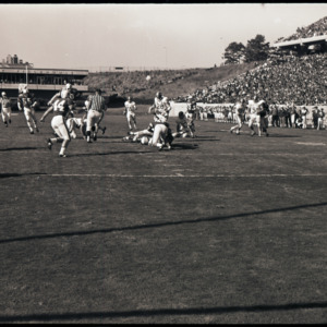 Football players and referees at NC State versus Duke game, circa 1969-1975
