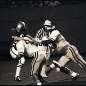 Football players and referee at NC State versus East Carolina game, 1973