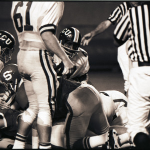 Football players and referee at NC State versus East Carolina game, 1973