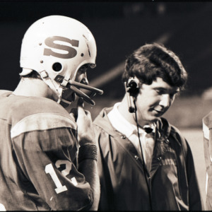 Football coach and players at NC State versus East Carolina game, circa 1969-1975