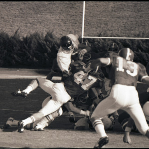 Football players and referee at NC State versus East Carolina game, circa 1969-1975