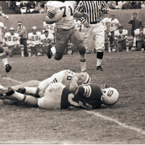 Football players and referee at NC State versus Florida State game, circa 1969-1975