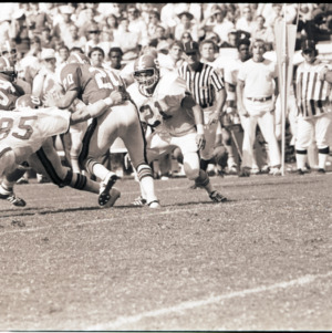 Football players and referees at NC State versus Georgia game, 1973