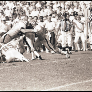 Football players and referees at NC State versus Georgia game, 1973