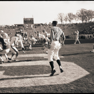 Football players and referee at NC State versus Houston game, circa 1969-1975