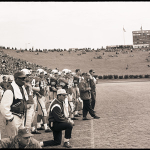 Football coaches and players at NC State versus Houston game, circa 1969-1975