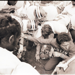 Football coach and players at NC State versus Indiana game, October 4, 1975