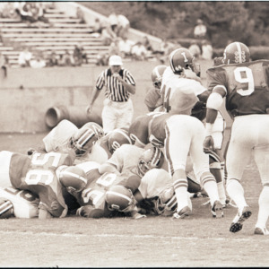 Football players and referee at NC State versus Indiana game, October 4, 1975